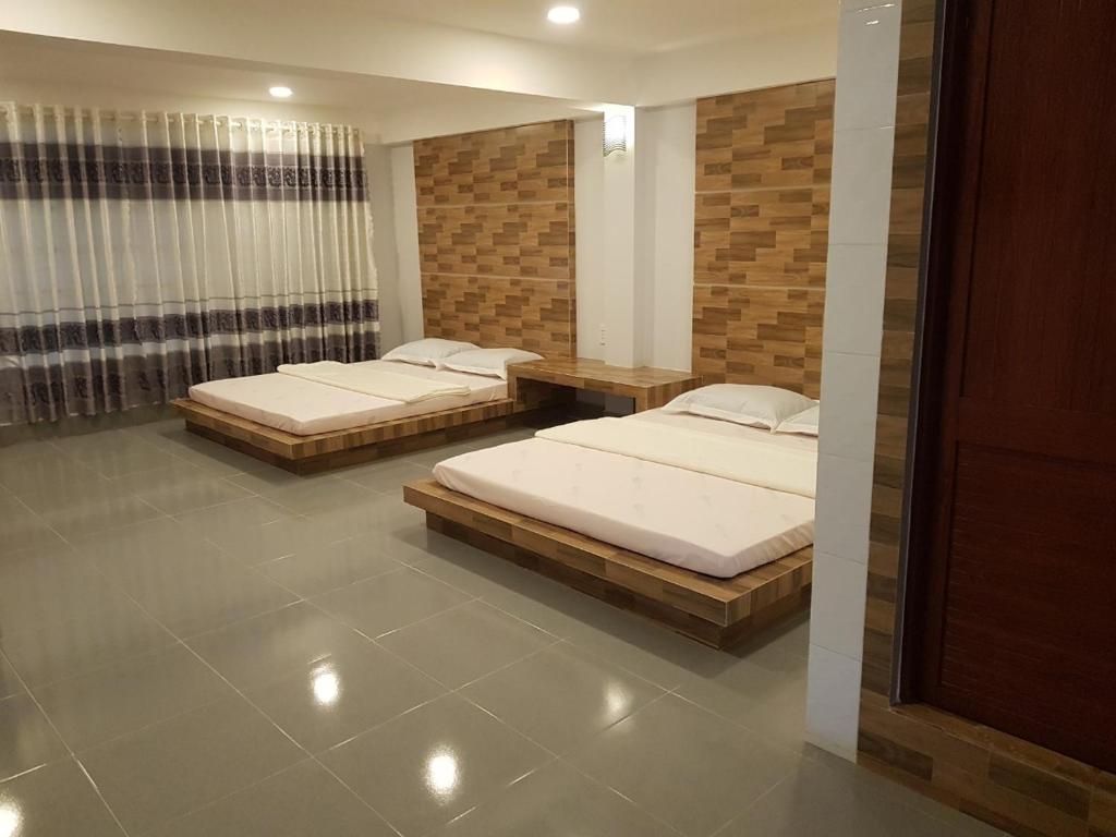 two twin beds in a room with at Lucky 190 in Chau Doc