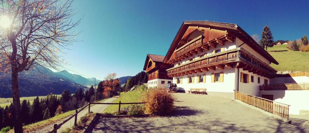 a large building with a roof on a mountain at Oberpapping in San Candido