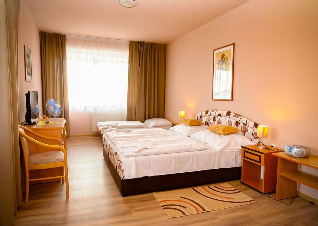 Postel nebo postele na pokoji v ubytování Hotel Atrium