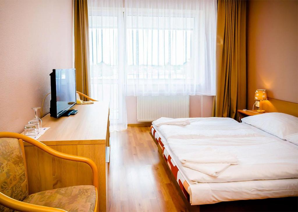 Postel nebo postele na pokoji v ubytování Hotel Atrium