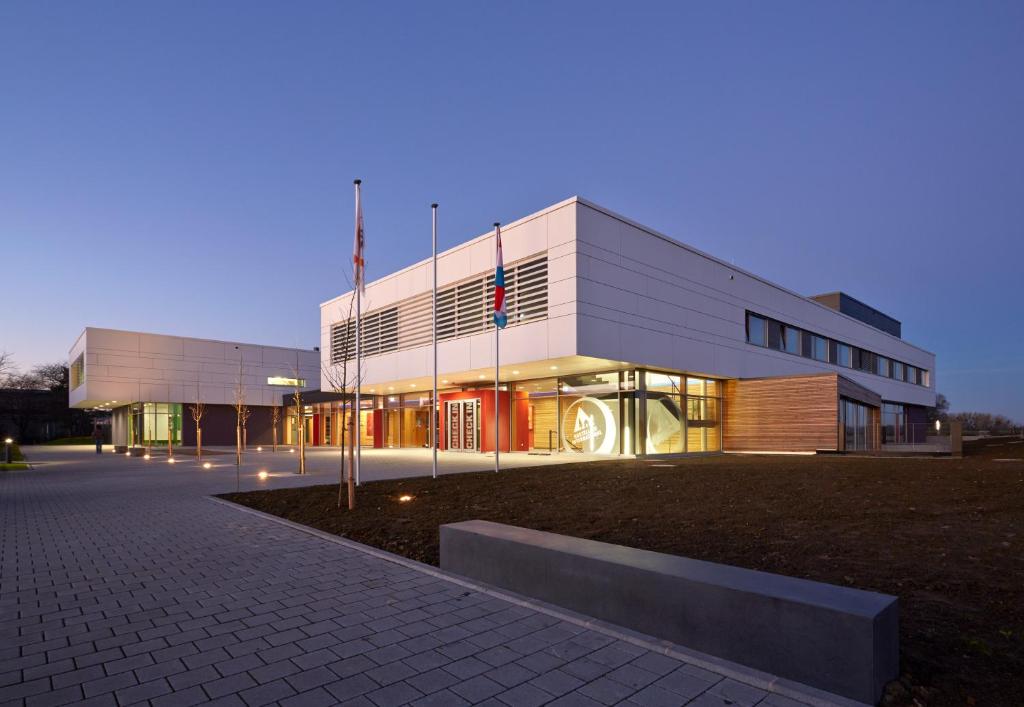 a large building with a lit up facade at night at Youth Hostel Beaufort in Beaufort