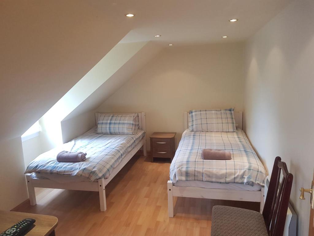 two beds in a room with a attic at Telford Road Apartment in Inverness