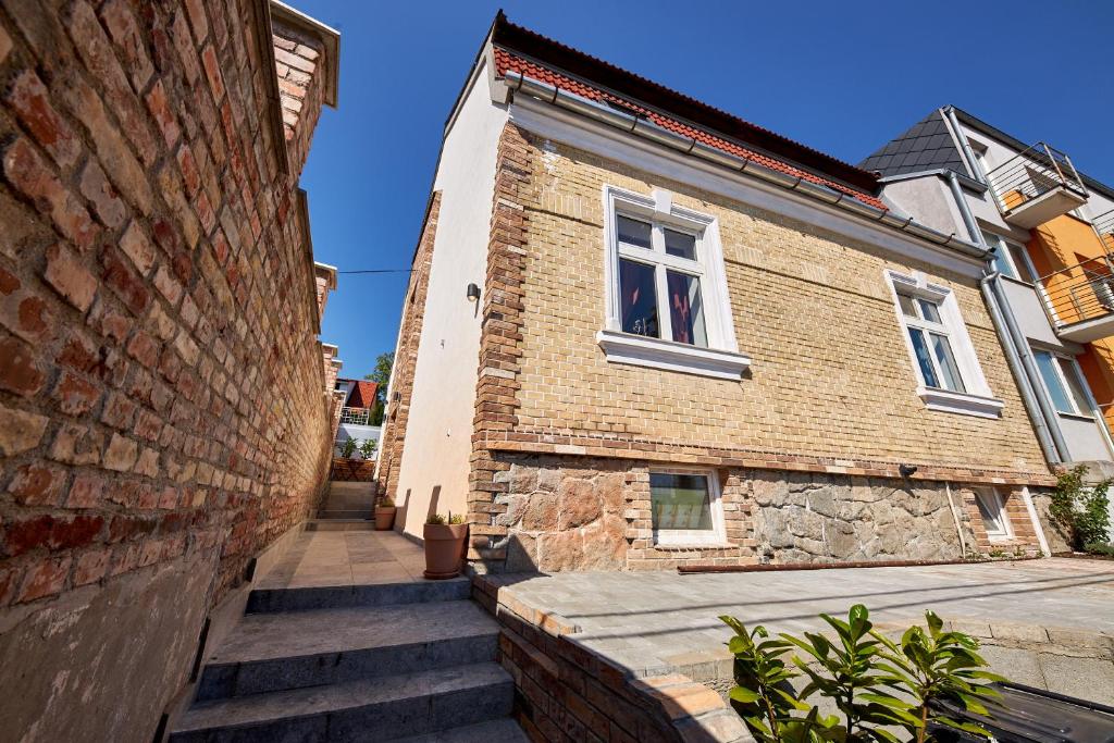 a brick building with stairs leading up to a window at Villa Bea in Bratislava