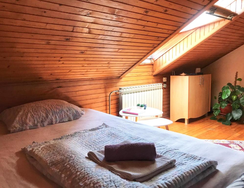 a bedroom with a large bed with a wooden ceiling at Villa Irena in Visoko