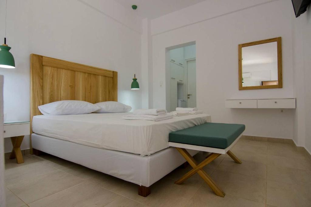 a bedroom with a bed and a mirror and a chair at Giorgos villa in Palekastron