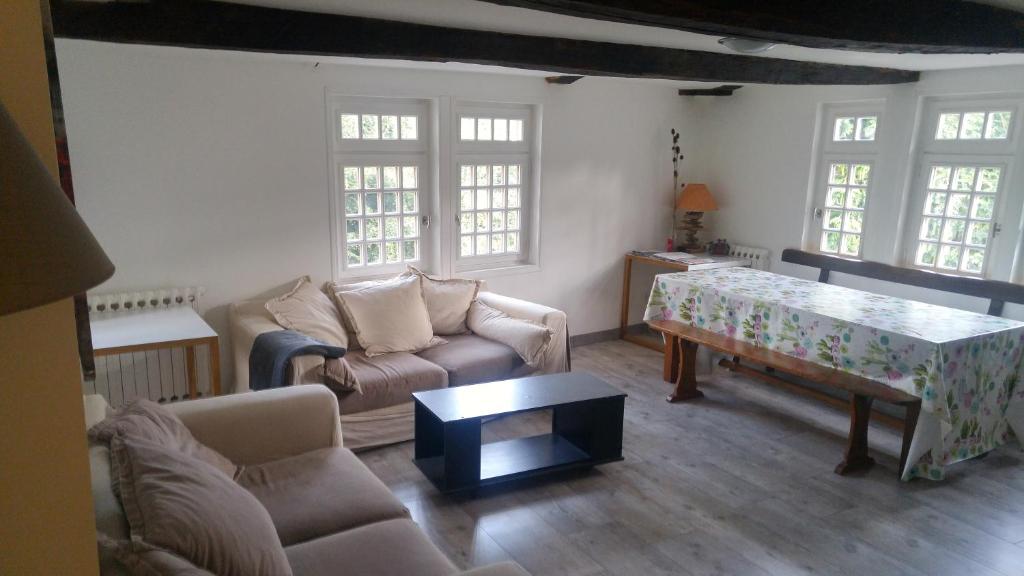 a living room with a couch and a table at Hostel du lapin blanc in Saint-Brieuc