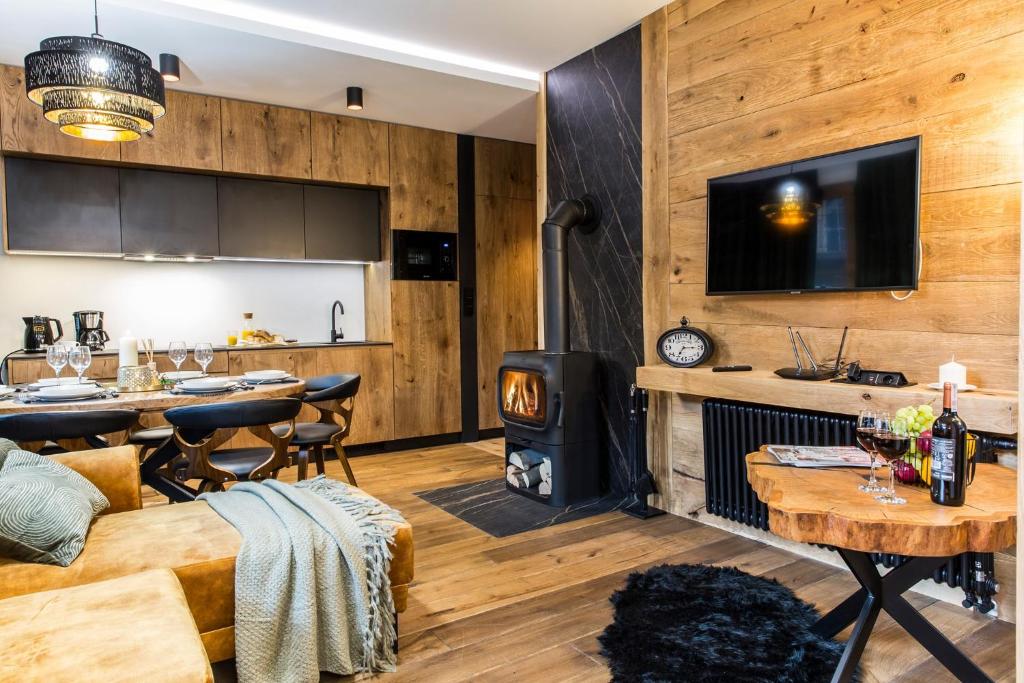 a living room with wood paneling and a wood stove at Nowy komfortowy Apartament & Spa Grizzly de lux in Zakopane