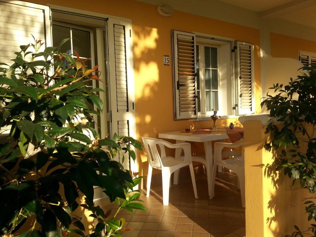 a kitchen with a table and a sink in a room at Residence Porto Ulisse in Parghelia