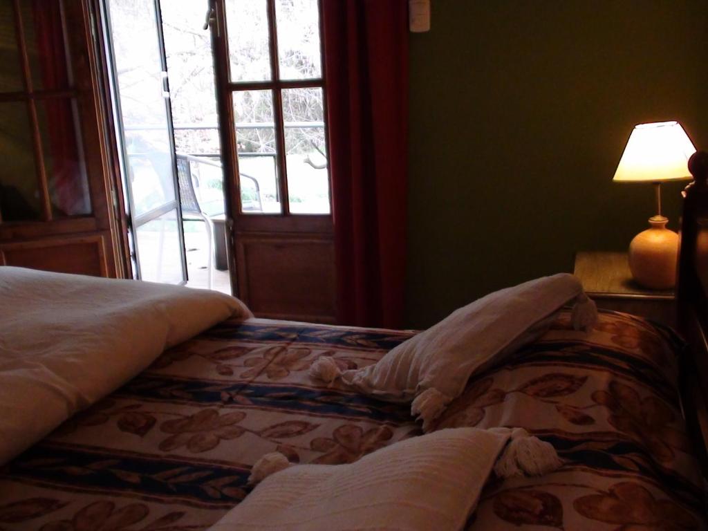 Postel nebo postele na pokoji v ubytování Manantial Hostería & Cabañas