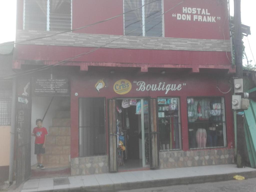 a man standing in the doorway of a building at Hostal Don Frank in San Carlos