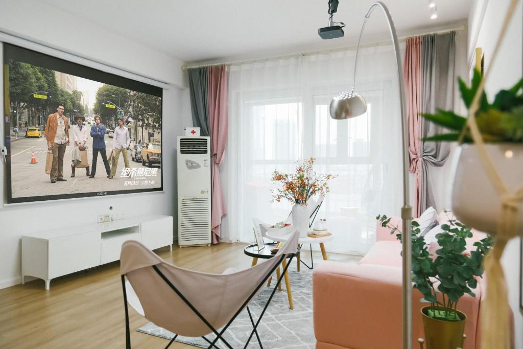 a living room with a flat screen tv on a wall at [Passenger] Wuhan，Qiekou District, Liji North Road in Wuhan