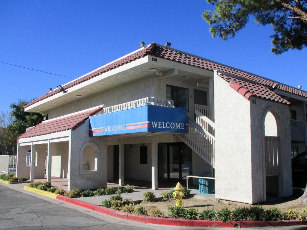 a building with a welcome sign in front of it at Studio 6-Barstow, CA in Barstow