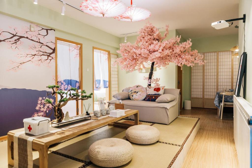 a living room filled with furniture and a pink tree at [Roader] Wuhan Jianghan District, Jinghan Avenue in Wuhan