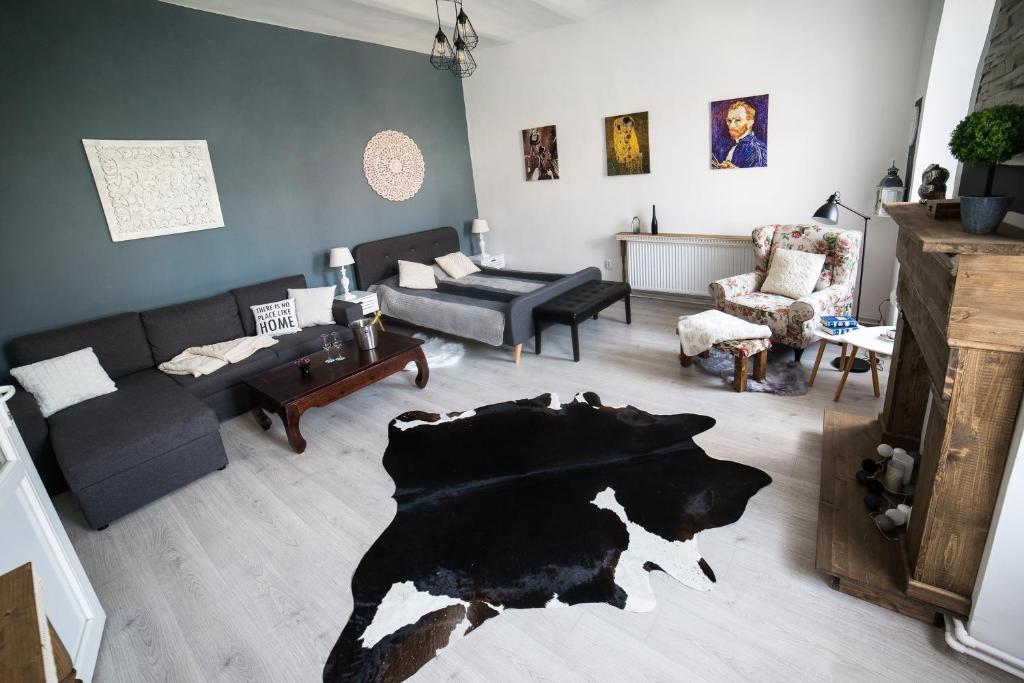 a living room with a cow rug on the floor at Ultra central apartment in Cluj-Napoca