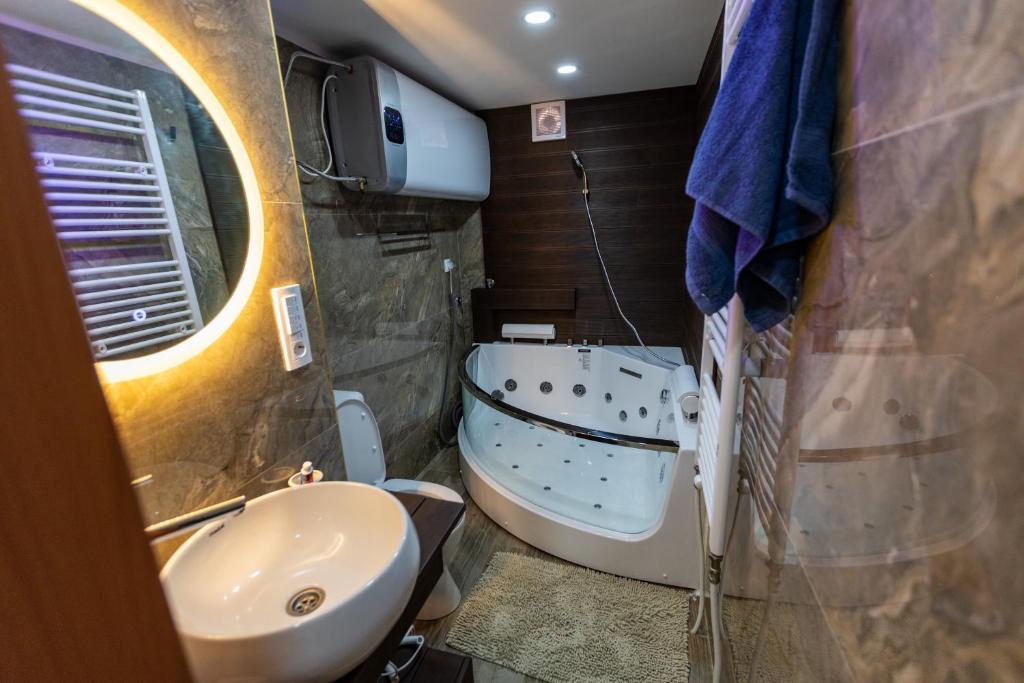 a small bathroom with a sink and a toilet at Deluxe dreams & spa in Šabac