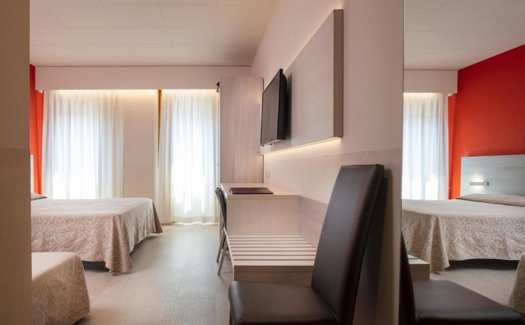 Postel nebo postele na pokoji v ubytování Alfa Fiera Hotel