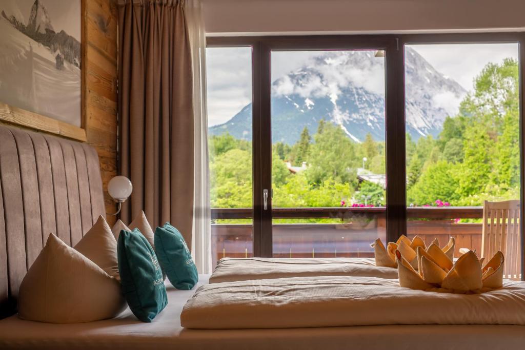 a bedroom with a bed with a view of a mountain at Hotel Alpennest in Leutasch
