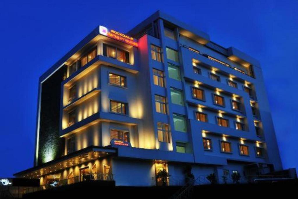 a tall building with lights on top of it at Hotel Rockdale in Visakhapatnam