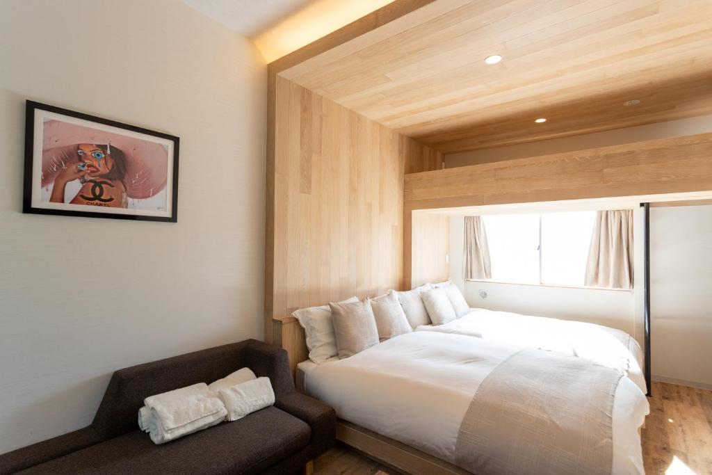 a bedroom with a bed and a window and a couch at Sakura Cross Hotel Shinjuku East in Tokyo