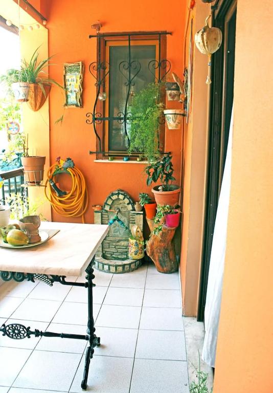 a room with a table and some potted plants at Victoria's Apartment in Thessaloniki