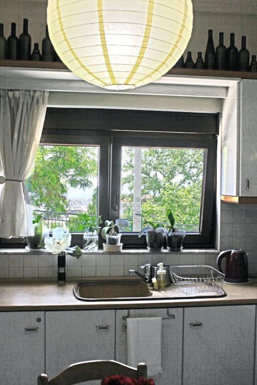 a kitchen with a sink and a window at Victoria's Apartment in Thessaloniki