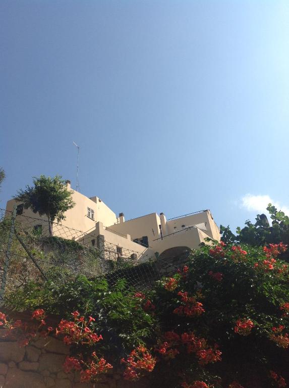a house on top of a hill with flowers at B&B Lacrêma in Finale Ligure