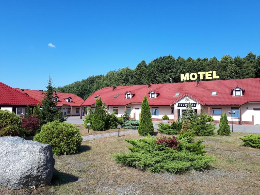 a motel with a lot of trees in front of it at Inter-Bar-Motel in Nowe Marzy
