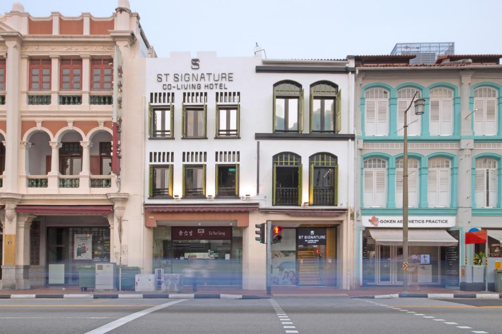 a group of buildings on a city street at ST Signature Chinatown in Singapore