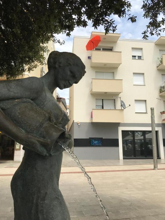 a statue of a woman holding a water hose at Apartment Romeo in Crikvenica