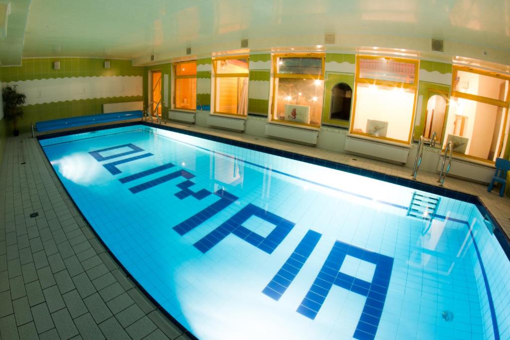 a large swimming pool in a building at Olimpia Resort & SPA in Szczyrk