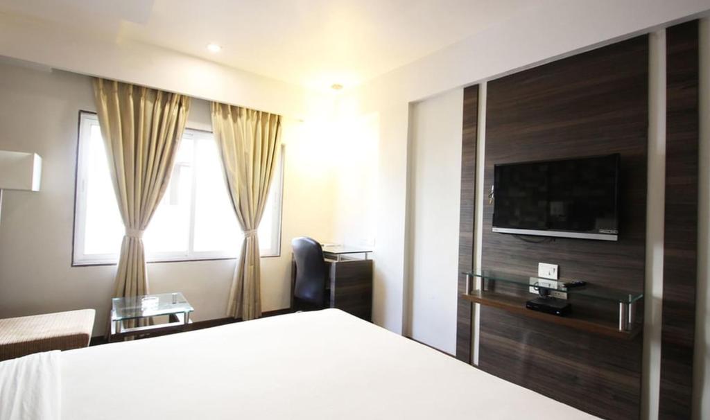 Postel nebo postele na pokoji v ubytování Hotel Aaram Orchard