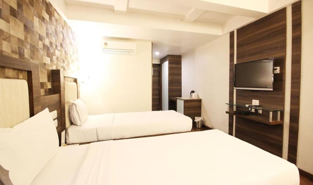 Postel nebo postele na pokoji v ubytování Hotel Aaram Orchard