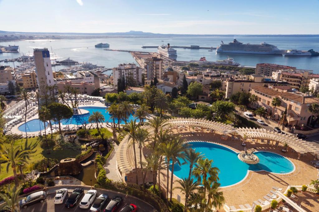 an aerial view of a city with two pools at GPRO Valparaiso Palace & Spa in Palma de Mallorca