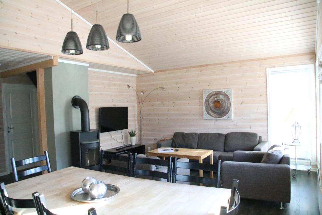 a living room with a couch and a table at Myrkdalen Resort Vårstølen apartment in Vossestrand
