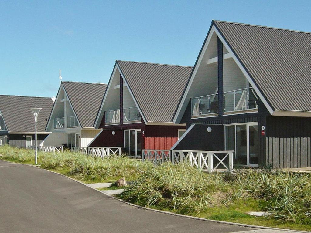 a row of houses on the side of a road at Holiday Home Strandblick II in Wendtorf