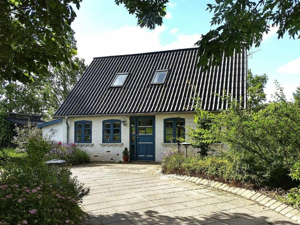 a white house with a black roof at Holiday home Humble in Humble