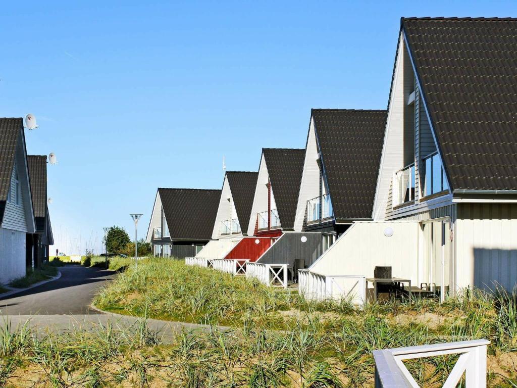 a row of houses with black roofs on a street at 6 person holiday home in Wendtorf in Wendtorf