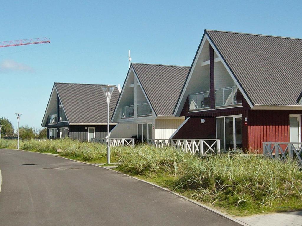 a row of houses on the side of a road at Holiday Home Strandblick in Wendtorf