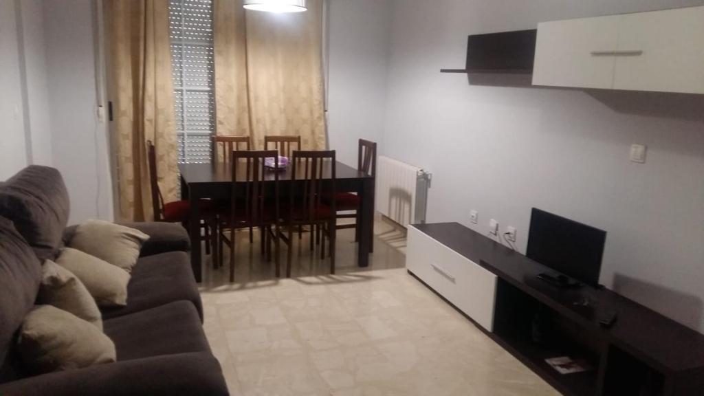 - un salon avec un canapé et une table à manger dans l'établissement Calle Quevedo, 27 Apartamento. Feria, à Albacete