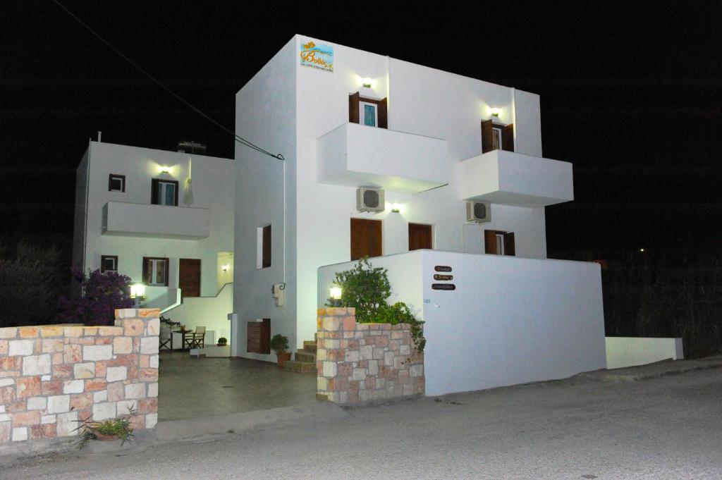 a large white building with lights on it at night at Vythos in Adamantas