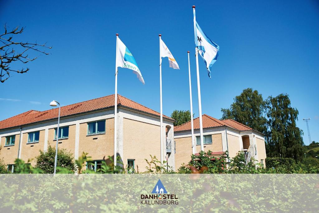 three flags flying in front of a building at Danhostel Kalundborg in Kalundborg