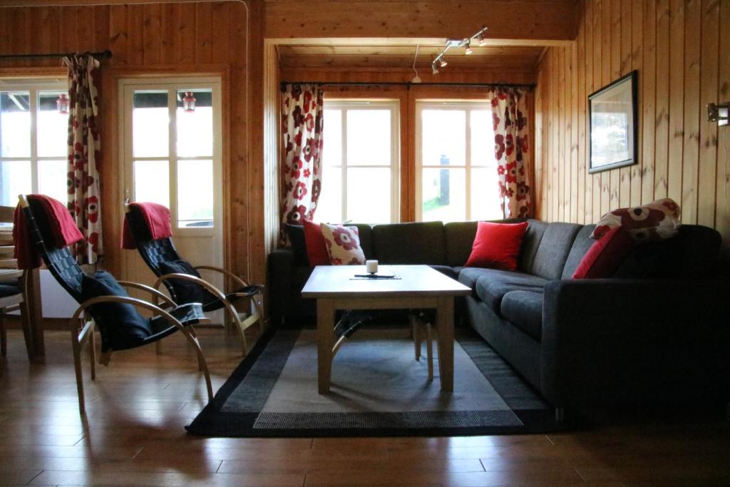 a living room with a couch and a table at Myrkdalen Resort Nedre Byggardslii apartment in Vossestrand