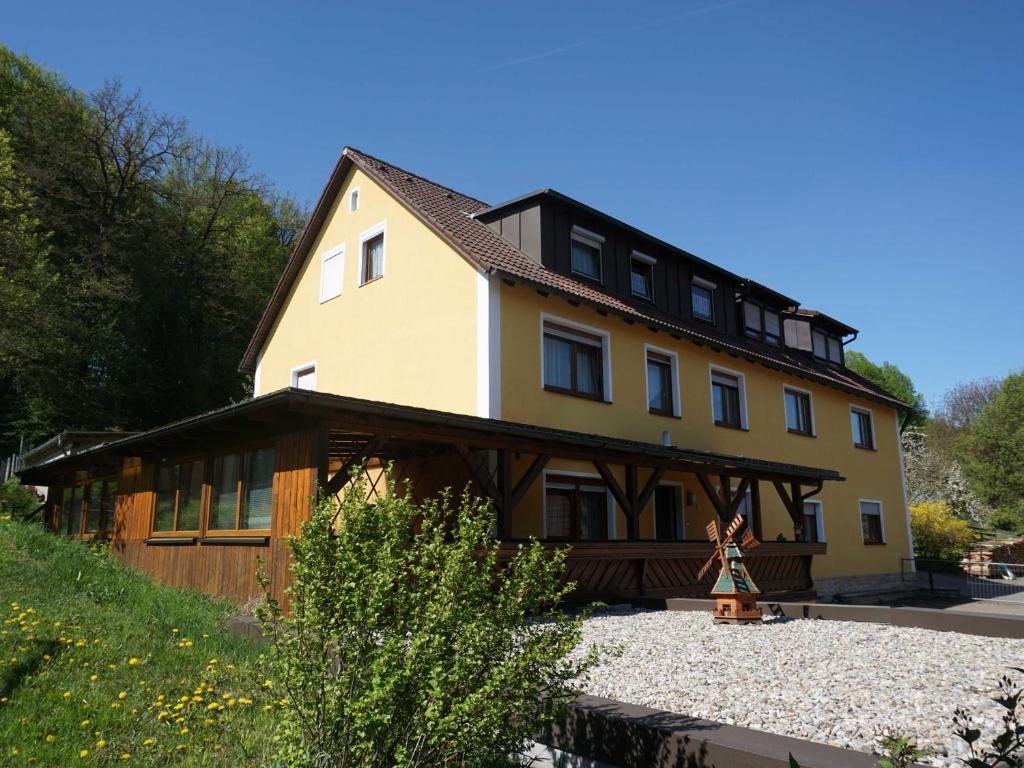 a large wooden house with a roof at Haus Burgblick in Obertrubach