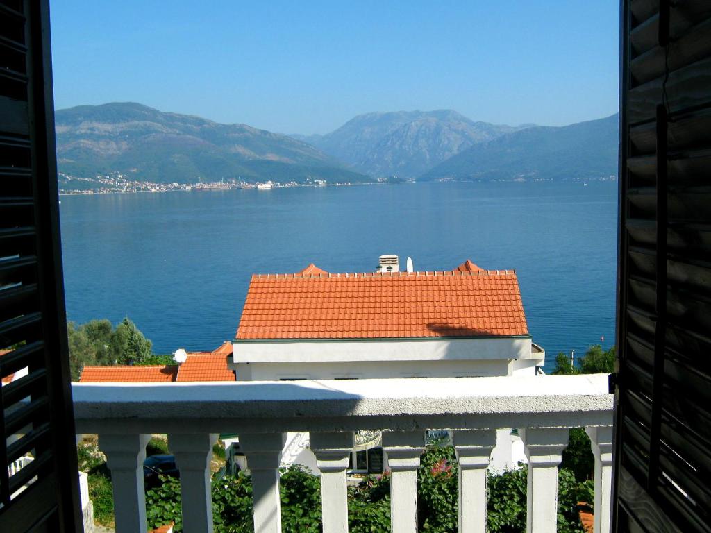 a view of a house with a view of the water at Apartments Ceca in Tivat