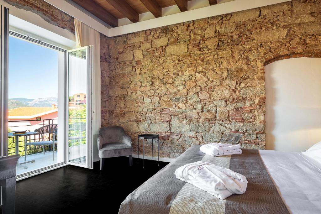 A bed or beds in a room at Raphael Hotel Arbatax