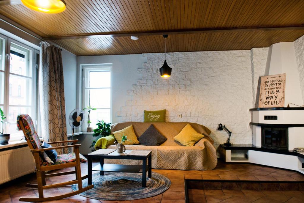 a living room with a couch and a fireplace at Spacious Klaipeda Apartment EV in Klaipėda