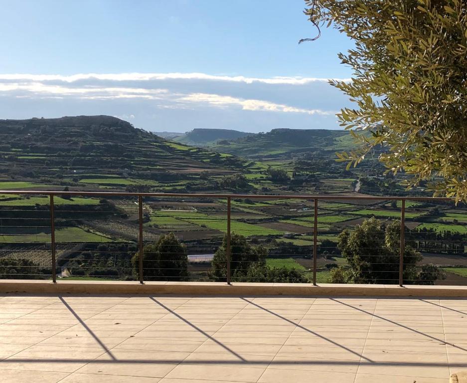 a view of a valley from a balcony at The Loft Gozo in Xagħra