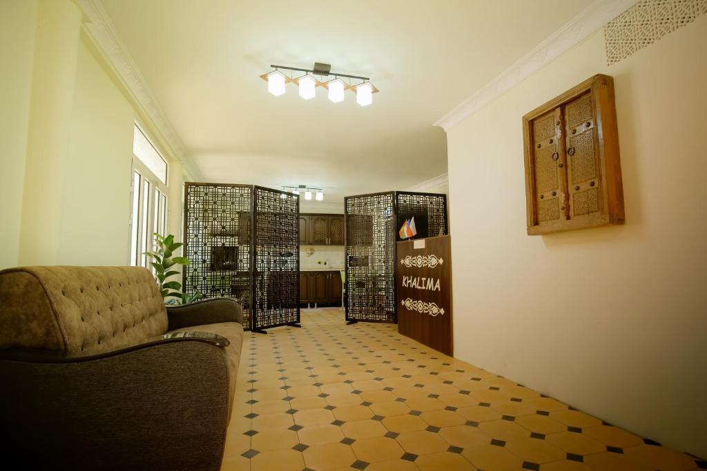 a living room with a couch and a chair at Khalima in Bukhara