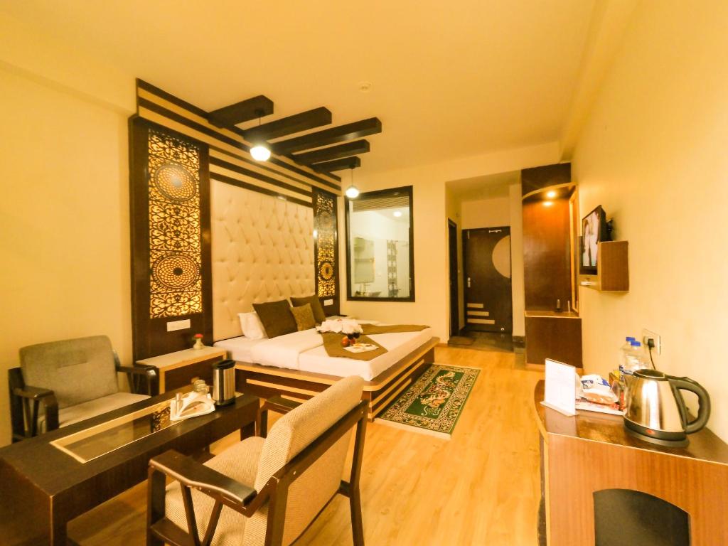 a living room filled with furniture and a computer at Hill House Manali -A home in mountains in Manāli