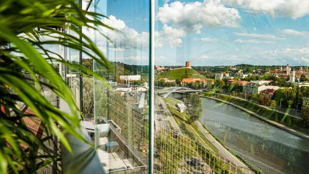 a view of a river and a city from a building at Vilnius city best view apartments in Vilnius
